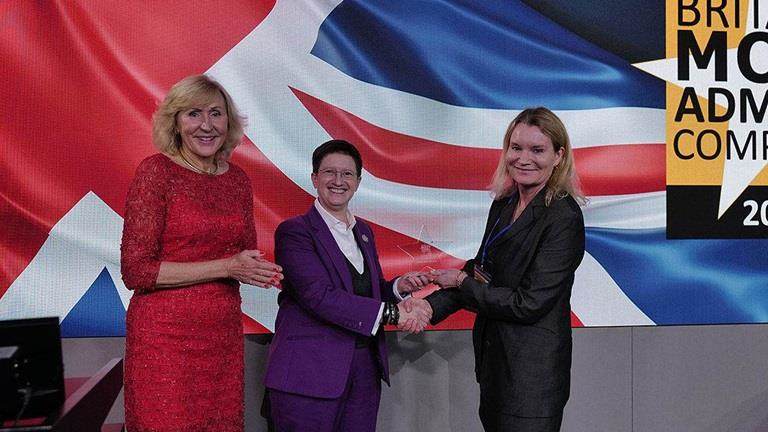 three women being presented an award